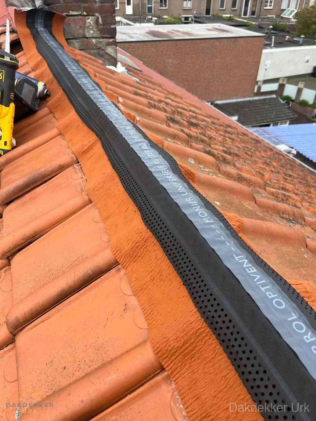 Plat dak aanbouw met bitumen naast schuin pannendak in Urk